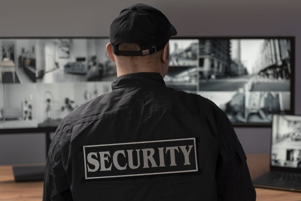 Picture of a man with the words security on his back
